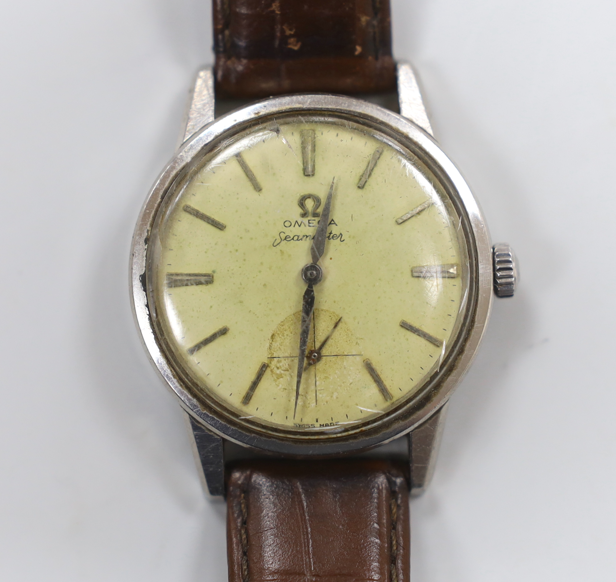 A gentleman's 1960's? stainless steel Omega Seamaster manual wind wrist watch, on associated leather strap.